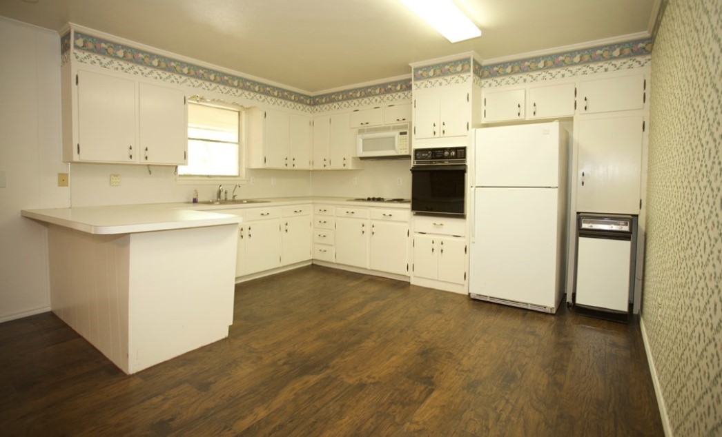 2709 Rebecca Drive Big Spring, TX 79720 - Photo 3 of 16 a kitchen with stainless steel appliances a refrigerator sink and white cabinets