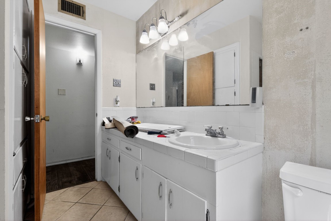 2709 Rebecca Drive Big Spring, TX 79720 - Photo 42 of 50 a bathroom with a double vanity sink mirror and toilet