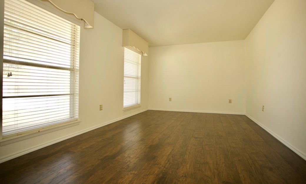 2709 Rebecca Drive Big Spring, TX 79720 - Photo 8 of 16 an empty room with wooden floor and windows