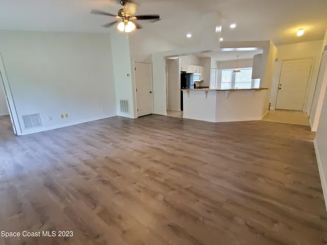 a view of a kitchen with a sink and a refrigerator