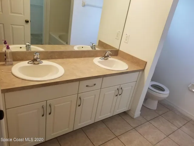 a bathroom with a sink mirror and toilet