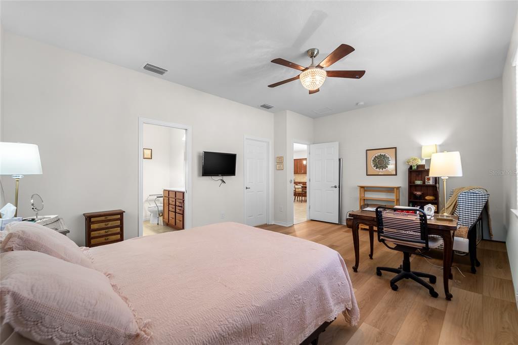 6306 Kenava Loop Palmetto, FL 34221 - Photo 12 of 31 a bedroom with a bed and a flat screen tv