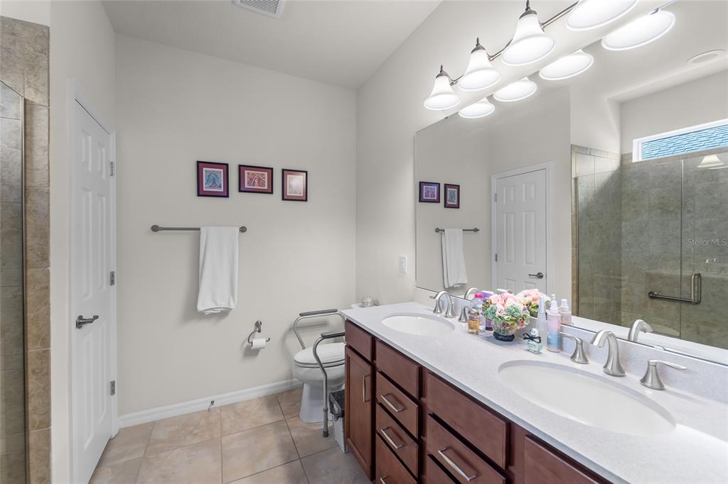 6306 Kenava Loop Palmetto, FL 34221 - Photo 13 of 31 a bathroom with a sink a vanity and a mirror