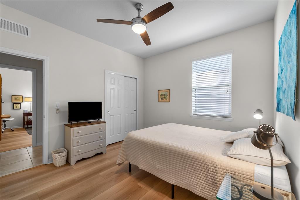 6306 Kenava Loop Palmetto, FL 34221 - Photo 15 of 31 a bedroom with a bed and a flat screen tv