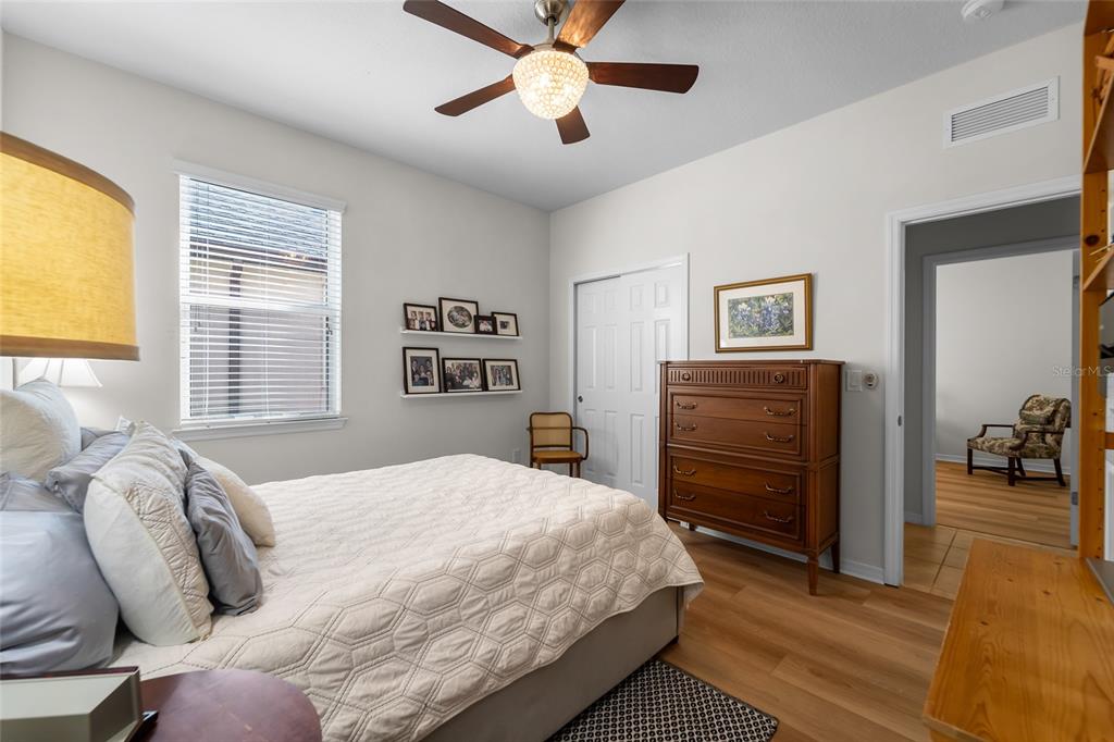 6306 Kenava Loop Palmetto, FL 34221 - Photo 17 of 31 a bedroom with a bed and wooden floor