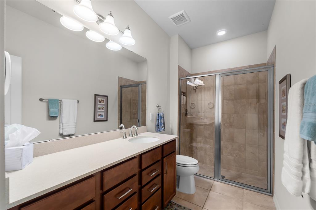 6306 Kenava Loop Palmetto, FL 34221 - Photo 18 of 31 a bathroom with a sink a toilet and shower