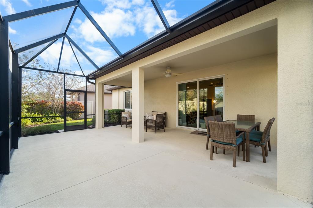 6306 Kenava Loop Palmetto, FL 34221 - Photo 24 of 31 a view of a patio with table and chairs under an umbrella