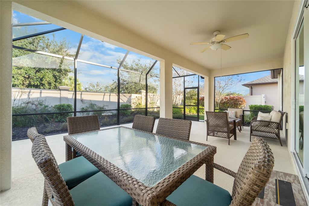 6306 Kenava Loop Palmetto, FL 34221 - Photo 3 of 31 a dining room with furniture a chandelier and wooden floor