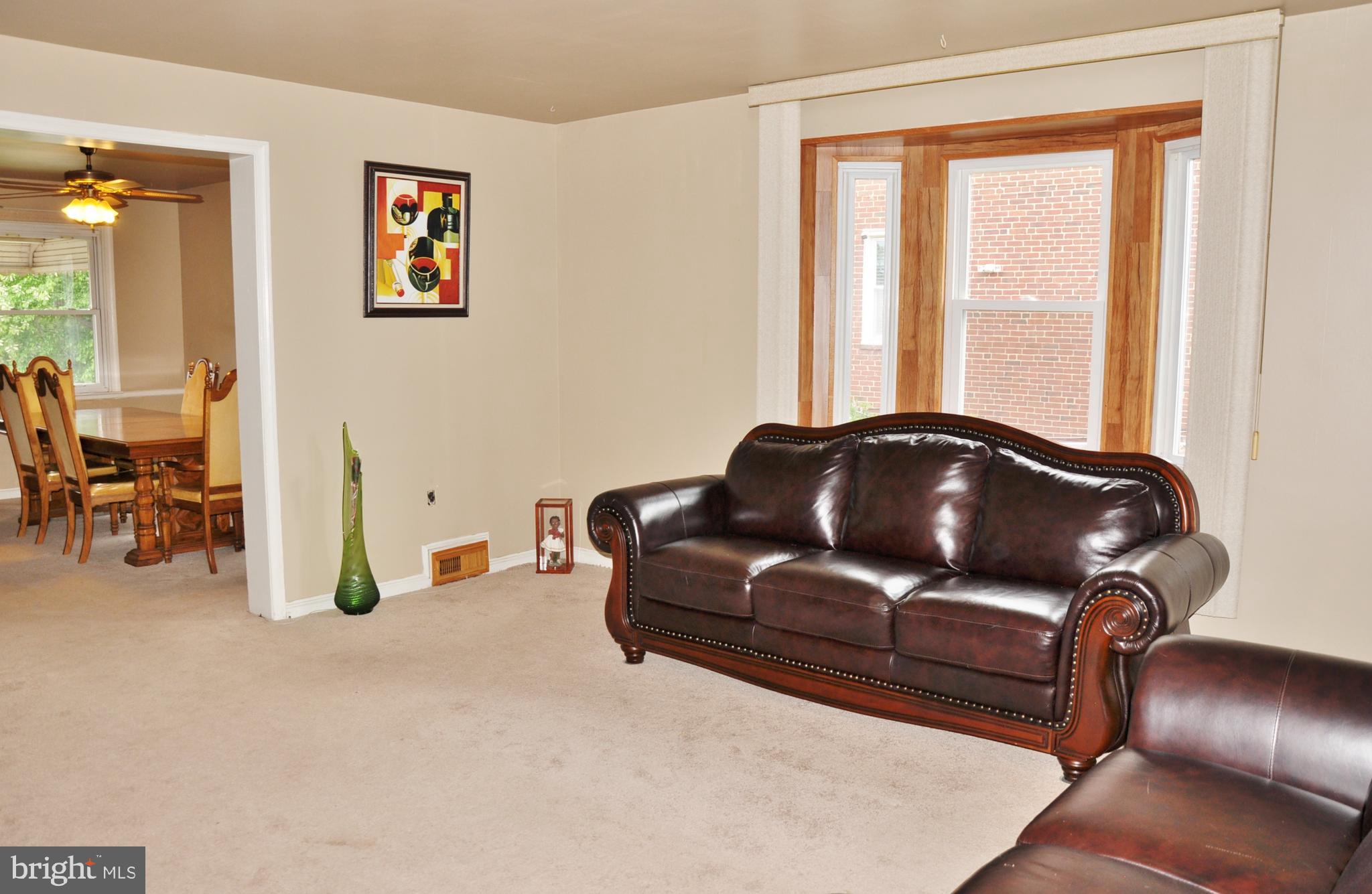 1335 Silverthorne Road Baltimore, MD 21239 - Photo 14 of 50 Living room with wood floors under the carpet