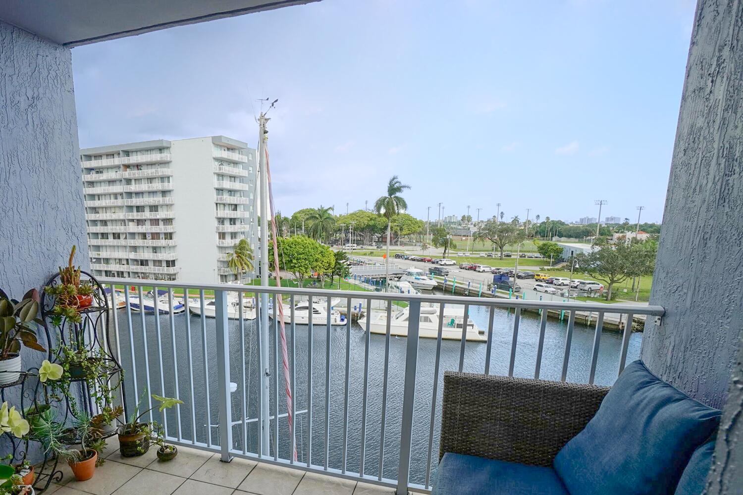 a view of roof deck with wooden fence and trees