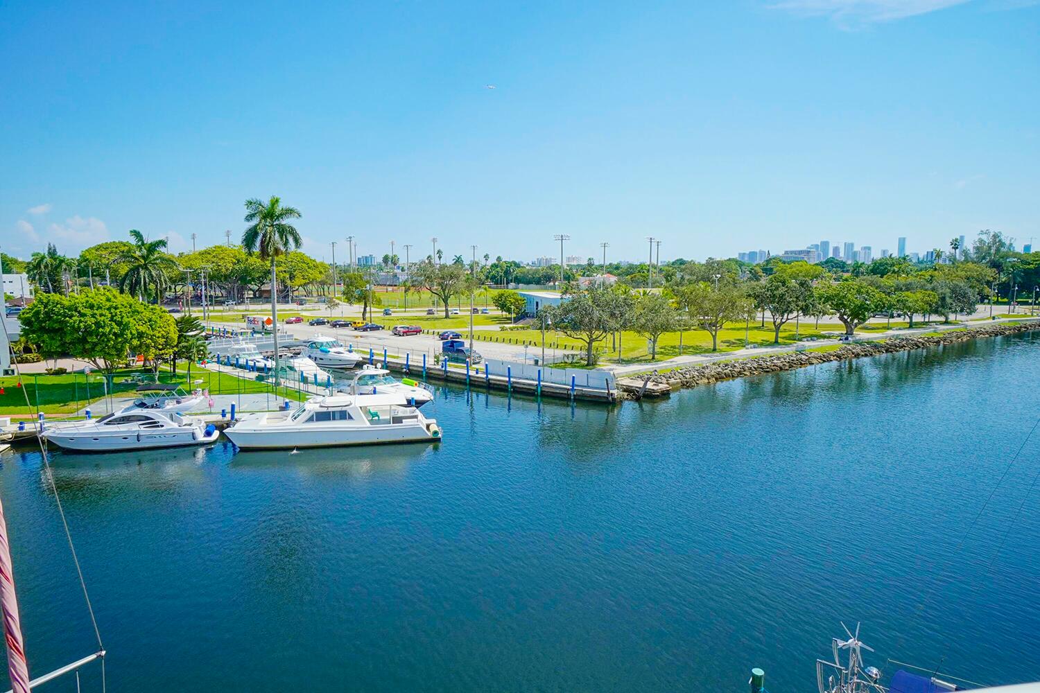 2415 Northwest 16th St Road, Unit 512 Miami, FL 33125 - Photo 2 of 17 a view of a lake with boats and trees in the background