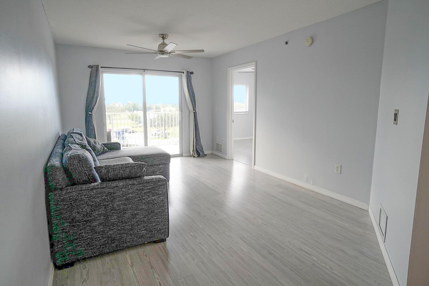 2415 Northwest 16th St Road, Unit 512 Miami, FL 33125 - Photo 4 of 17 a living room with furniture and a large window