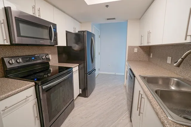 a kitchen with a refrigerator stove and microwave