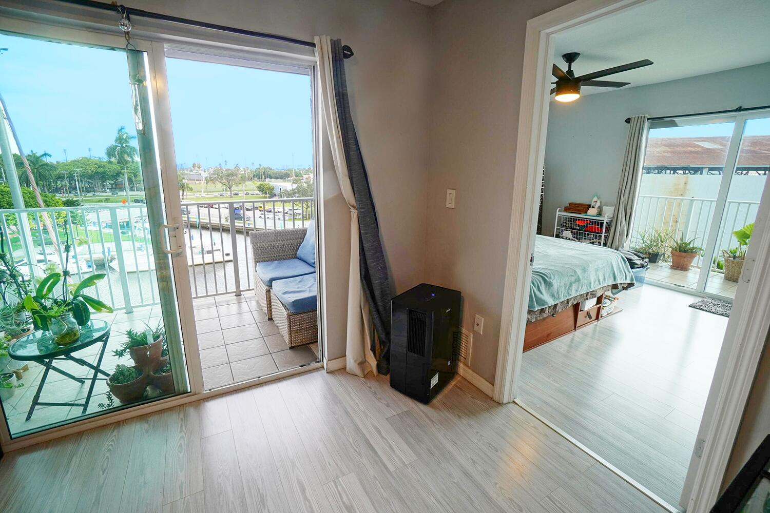 2415 Northwest 16th St Road, Unit 512 Miami, FL 33125 - Photo 7 of 17 a view of a living room and a floor to ceiling window with wooden floor