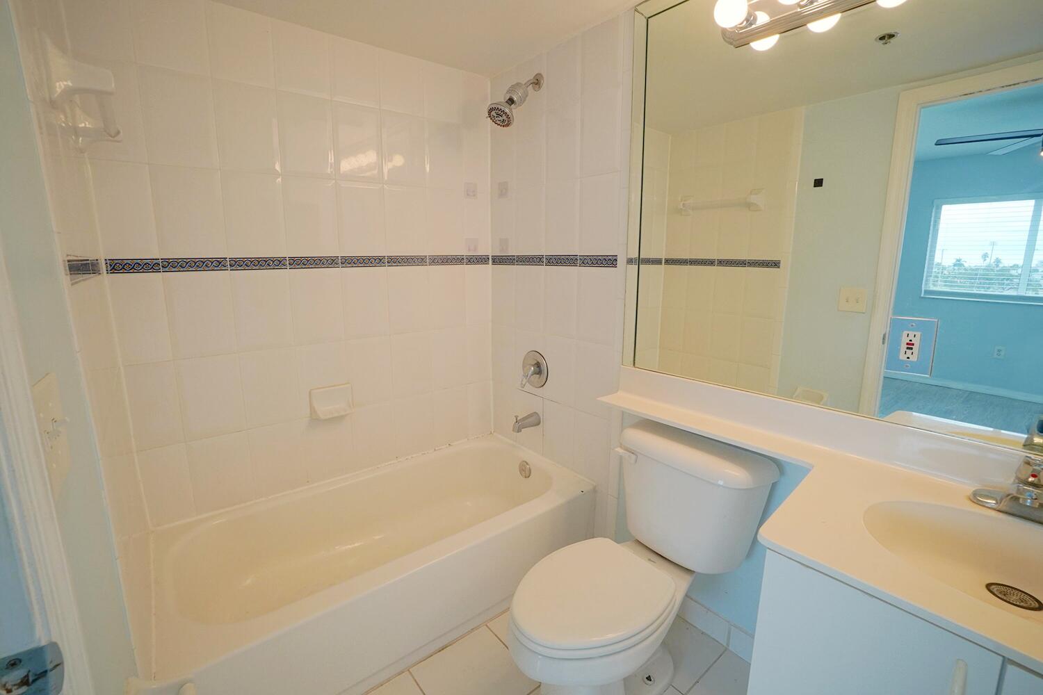 2415 Northwest 16th St Road, Unit 512 Miami, FL 33125 - Photo 10 of 17 a bathroom with a sink a toilet and shower