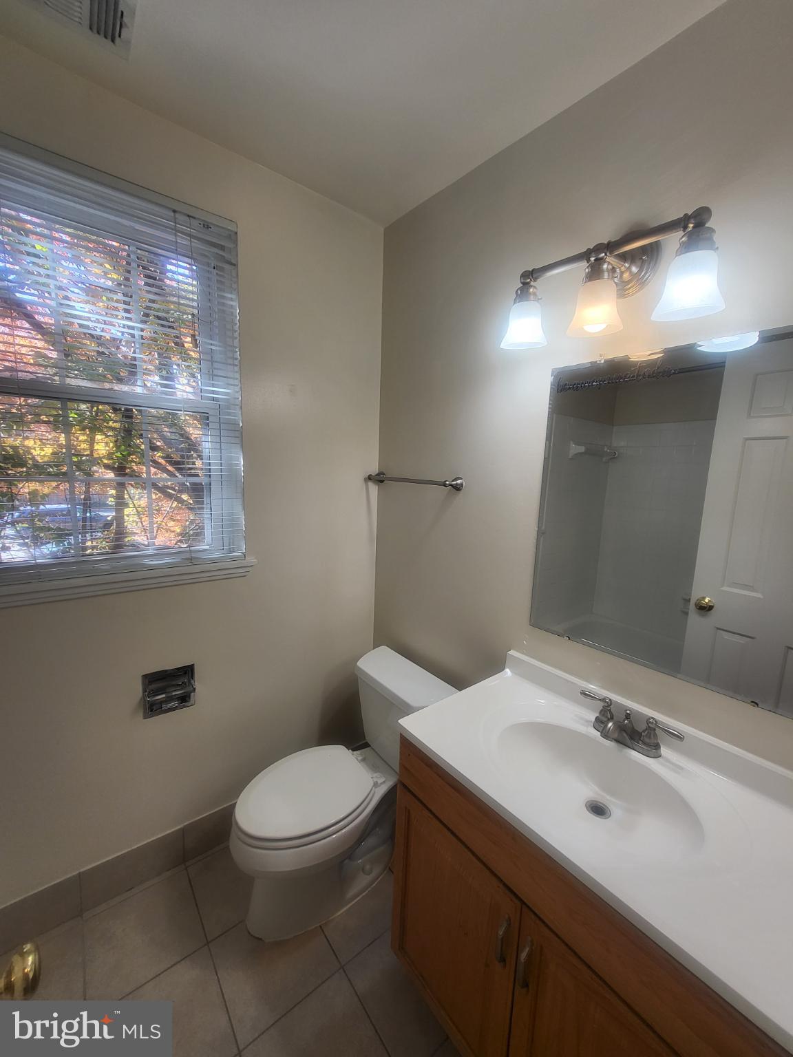 3279 South Stafford Street, Unit B1 Arlington, VA 22206 - Photo 21 of 39 a bathroom with a toilet a sink and mirror