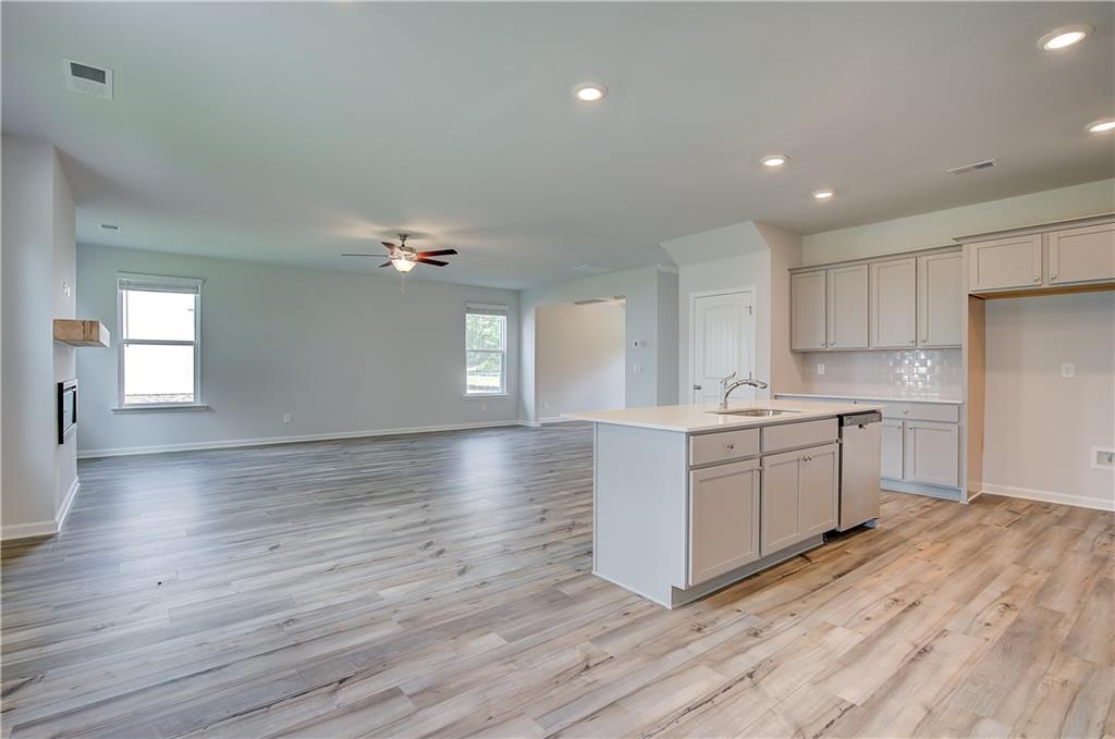 149 St Anne's Place Covington, GA 30016 - Photo 14 of 30 a kitchen with a refrigerator and white cabinets