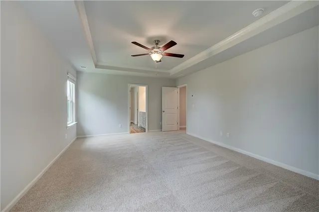 a view of an empty room with a ceiling fan