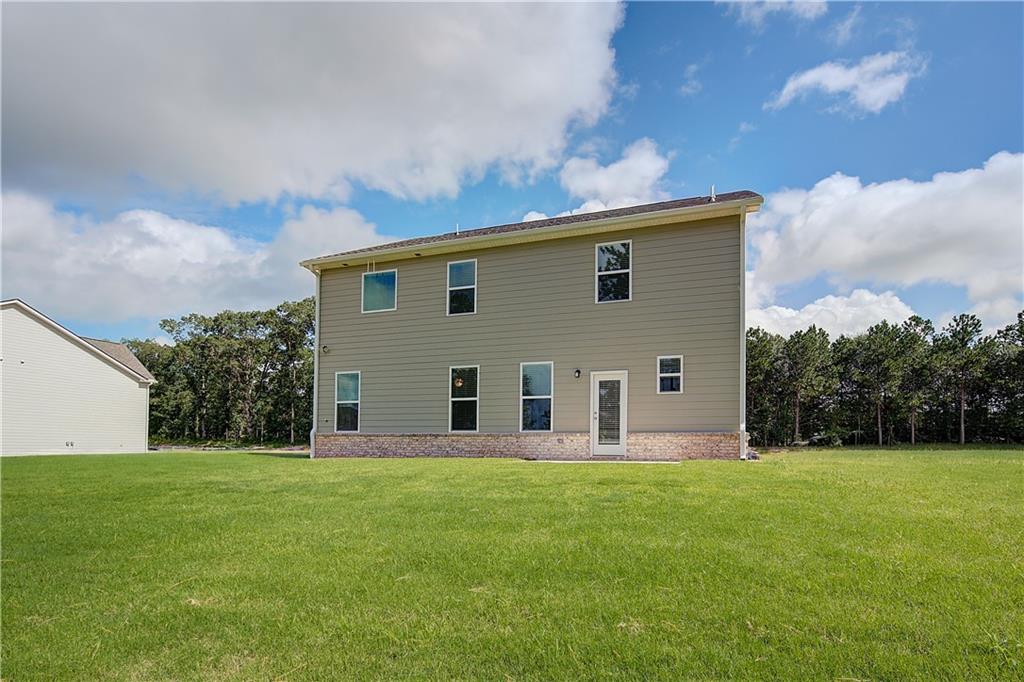 149 St Anne's Place Covington, GA 30016 - Photo 30 of 30 a front view of house with yard and trees in the background