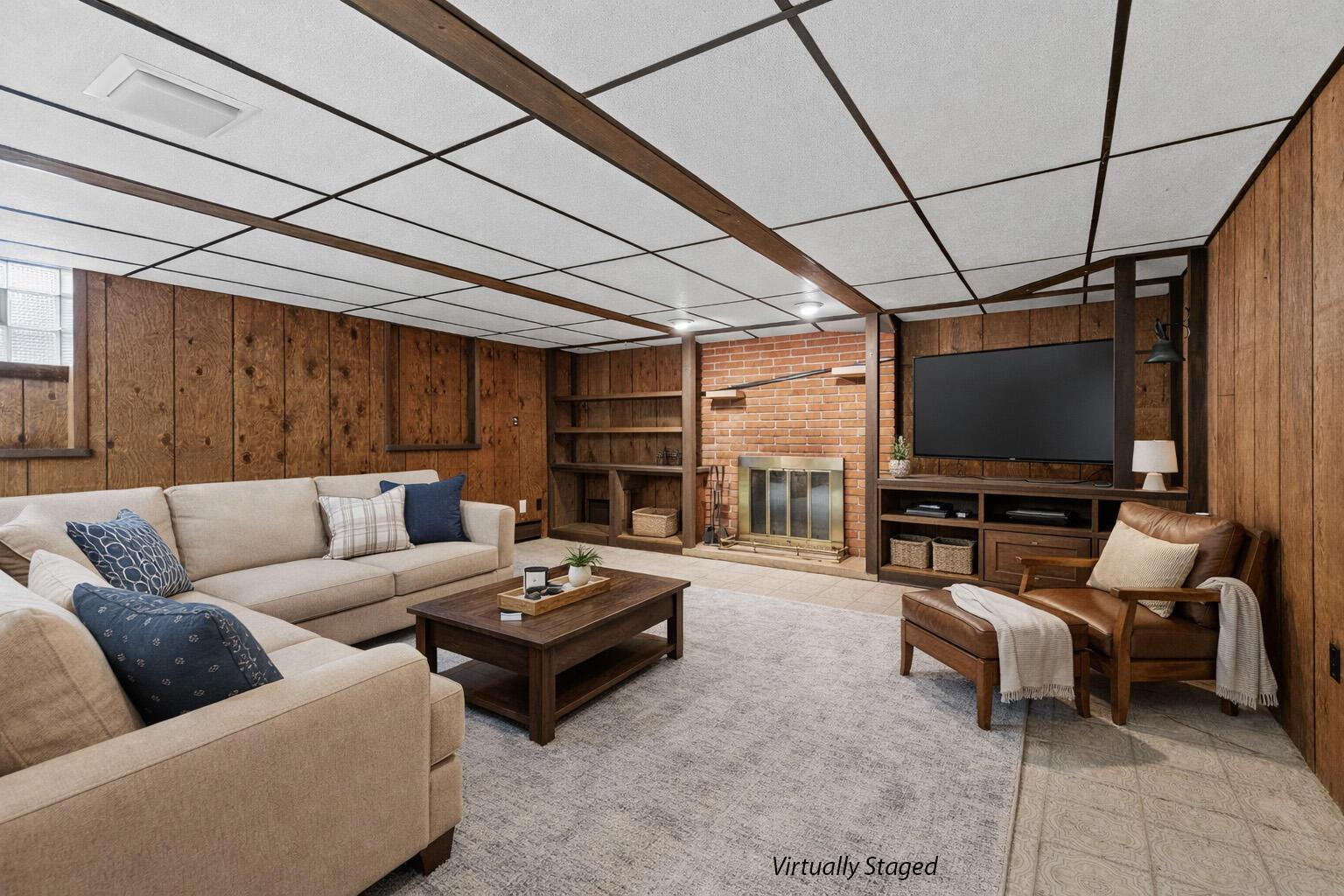 6982 Lee Road Westerville, OH 43081 - Photo 46 of 71 • Neutral vinyl flooring • Paneled walls • Acoustic ceiling tiles with fluorescent lighting • Can lighting • Woodburning, brick fireplace • Baseboard heat • (2) glass block windows • Built-in book shelves • Full wall of closets (cedar lined)
