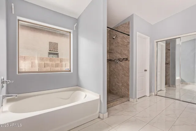 a bathroom with a bathtub and shower