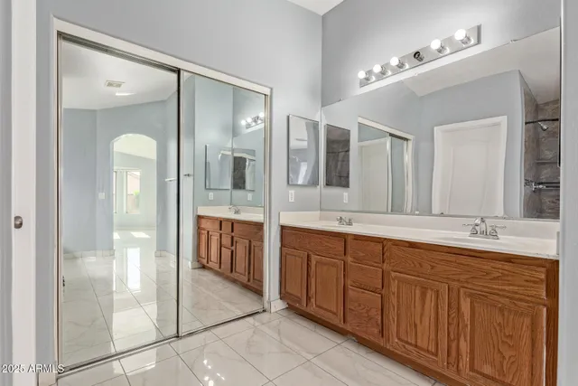 a spacious bathroom with a double vanity sink shower and a mirror