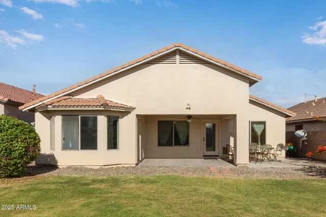 a view of a white house with a large windows yard and porch