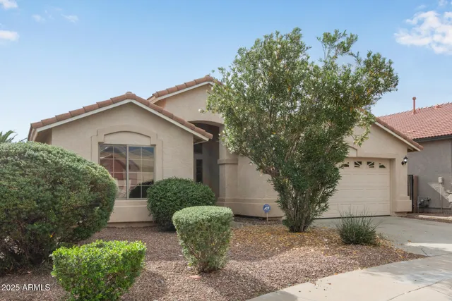 a view of a house with a yard and plants