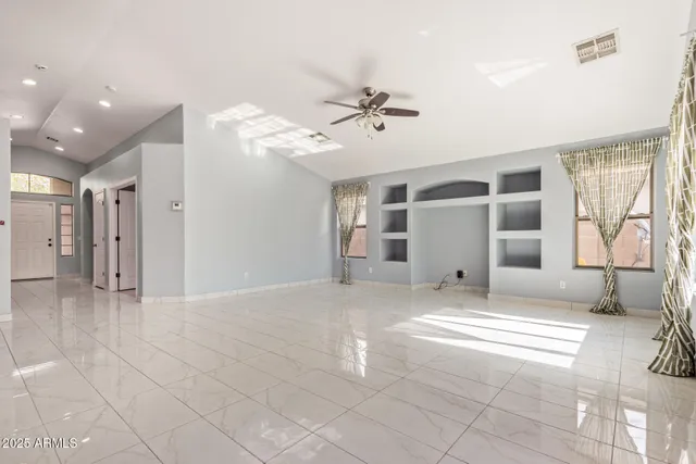 a view of a livingroom with a furniture and ceiling fan