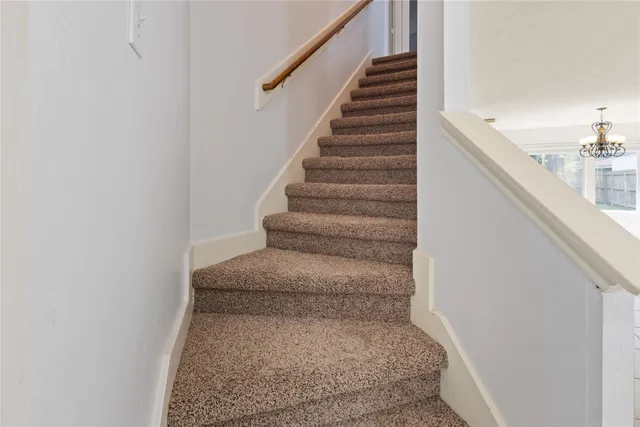 a view of staircase with white walls