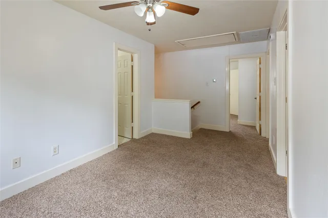 an empty room with chandelier fan