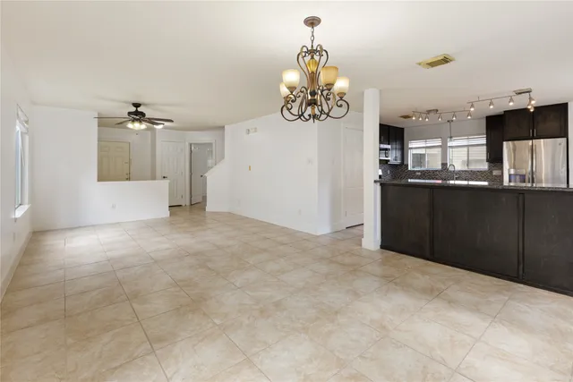 a view of a kitchen with a sink and cabinets
