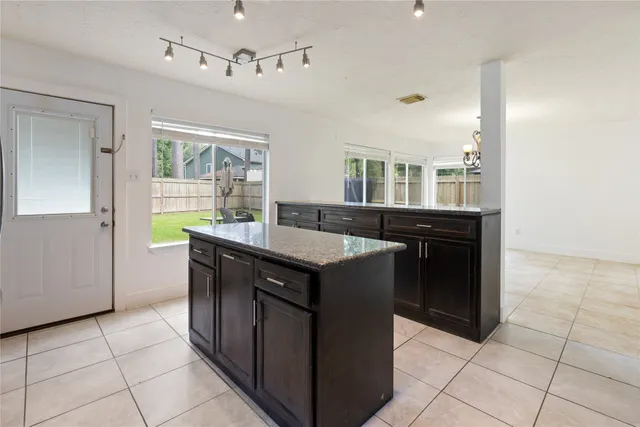 a kitchen with granite countertop a sink and a stove
