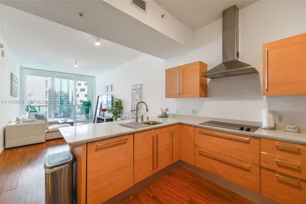 a kitchen with stainless steel appliances a sink stove and cabinets