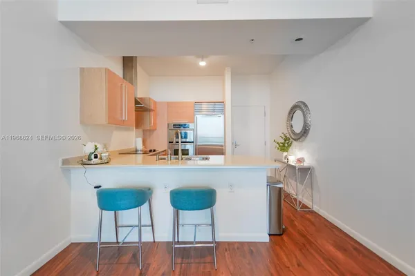 a kitchen with cabinets table and chairs