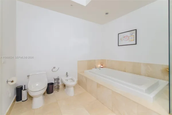 a bathroom with a toilet and a bathtub