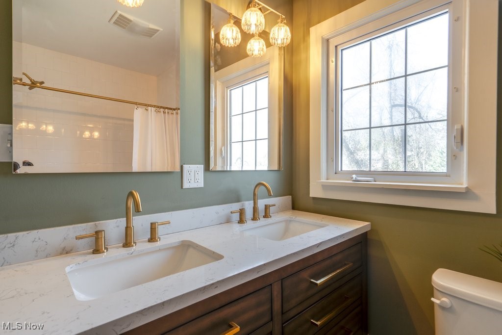 199 Edgerton Road Akron, OH 44303 - Photo 45 of 49 Full bath with double vanity, visible vents, toilet, and a sink