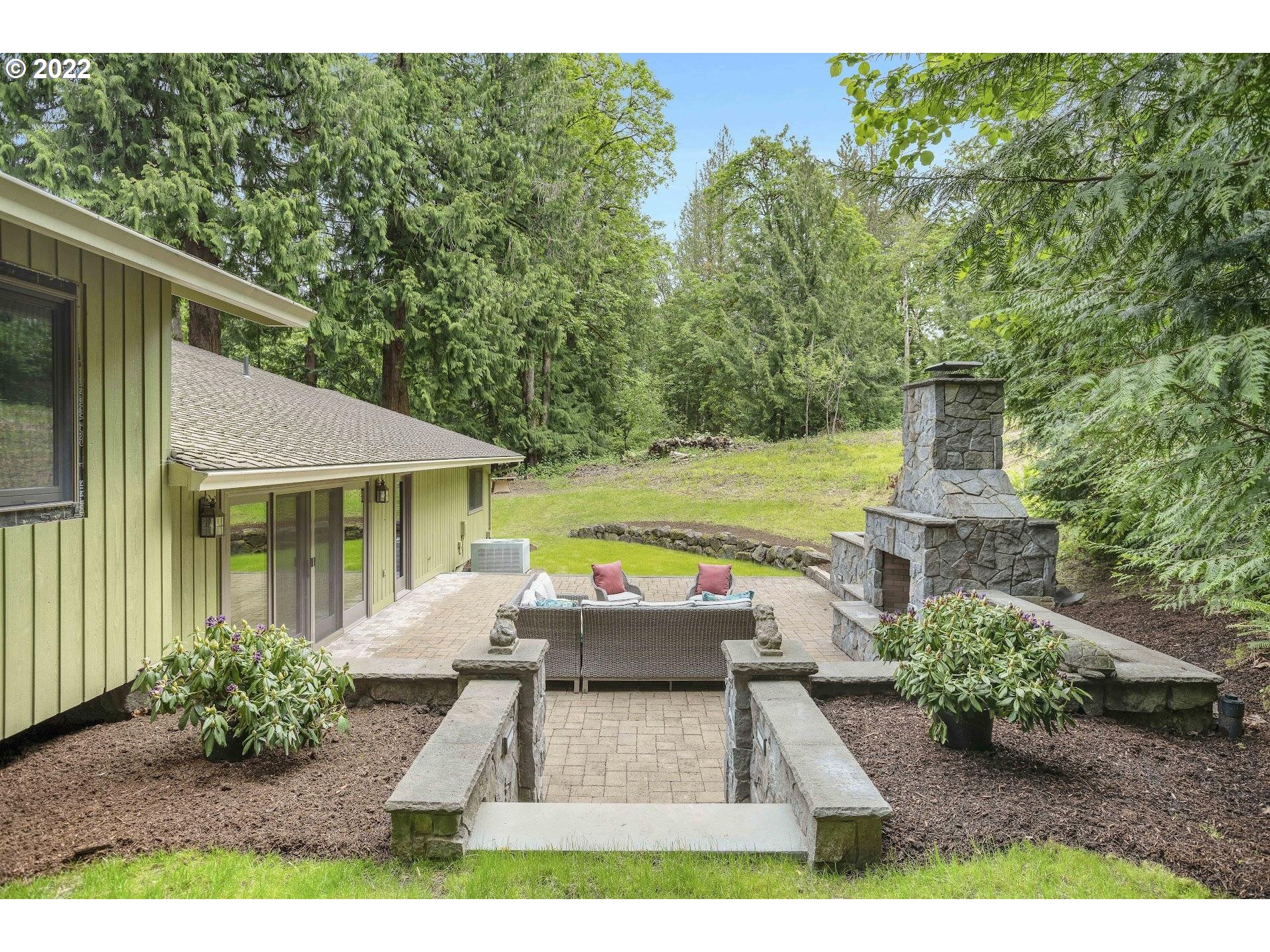 7531 Southeast Barbara Welch Road Portland, OR 97236 - Photo 25 of 32 a view of a patio with table and chairs potted plants and large tree