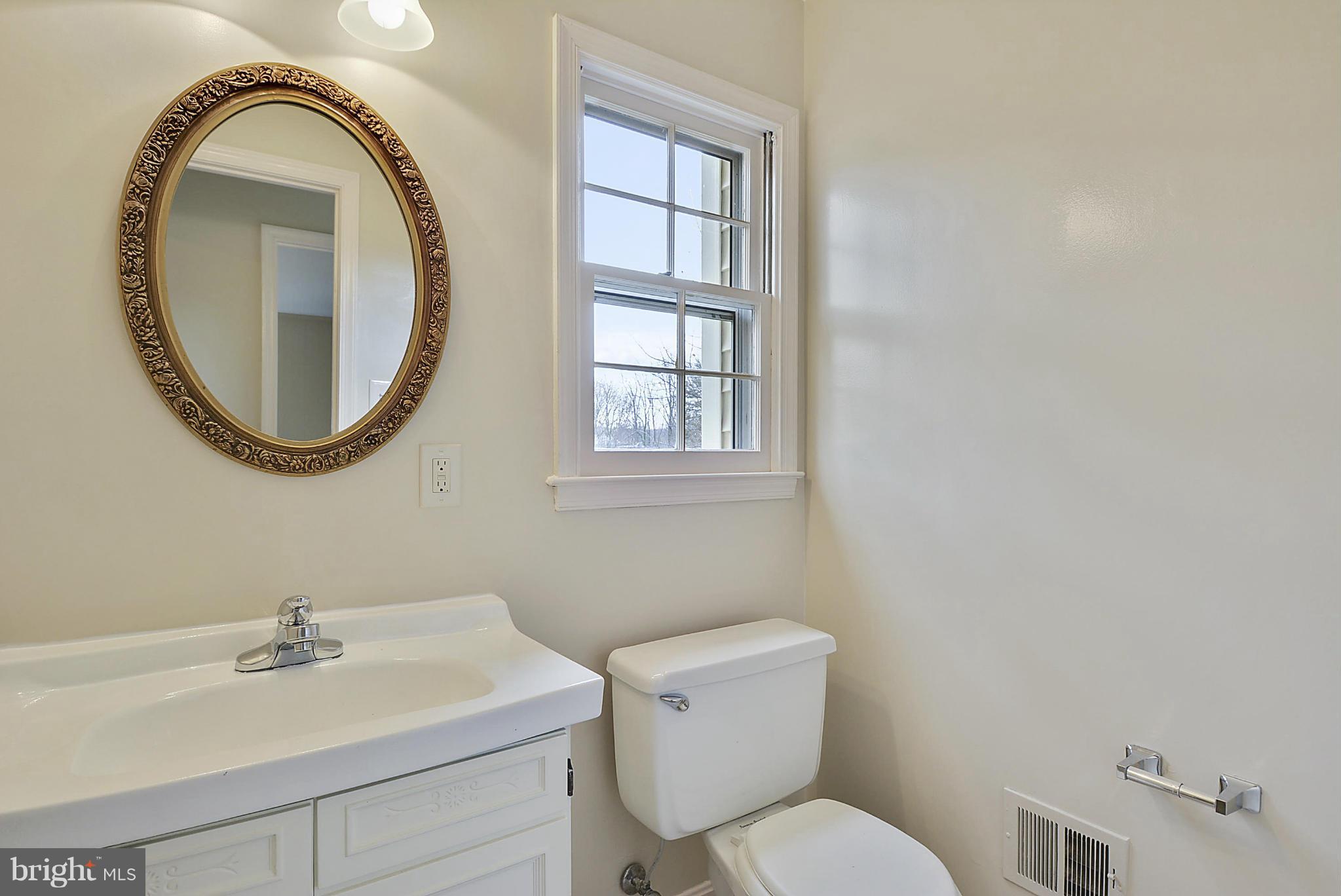 1716 Arbor View Road Silver Spring, MD 20902 - Photo 14 of 30 a bathroom with a toilet a sink and a mirror