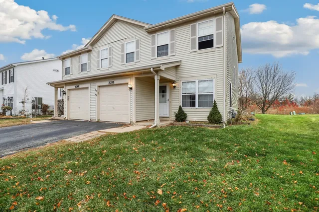 a view of a house with backyard and garden