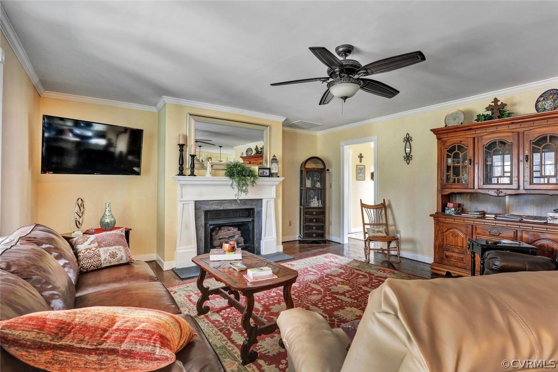 4515 Three Chopt Road Gum Spring, VA 23065 - Photo 12 of 36 a living room with furniture a flat screen tv and a fireplace