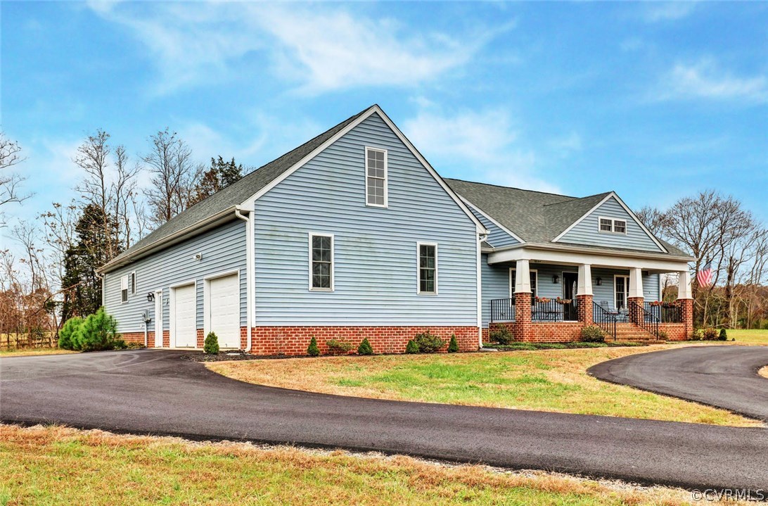 4515 Three Chopt Road Gum Spring, VA 23065 - Photo 3 of 36 a view of a white house with a small yard and plants