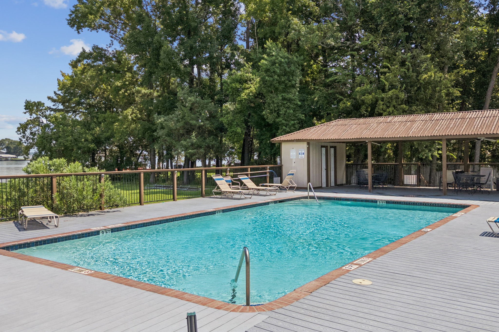 500 River Road, Unit 106 Montgomery, TX 77356 - Photo 28 of 32 Enjoy the pool with lake views and cabana providing a shady retreat. Pool is open 24/7.