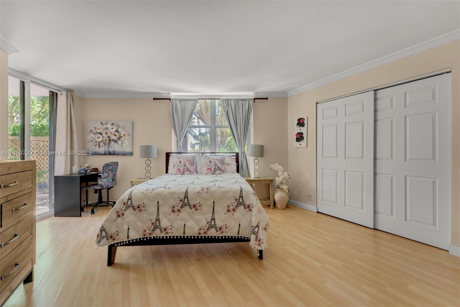 2000 Towerside Terrace, Unit 308 Miami, FL 33138 - Photo 13 of 16 a bedroom with a bed and a table in it with window