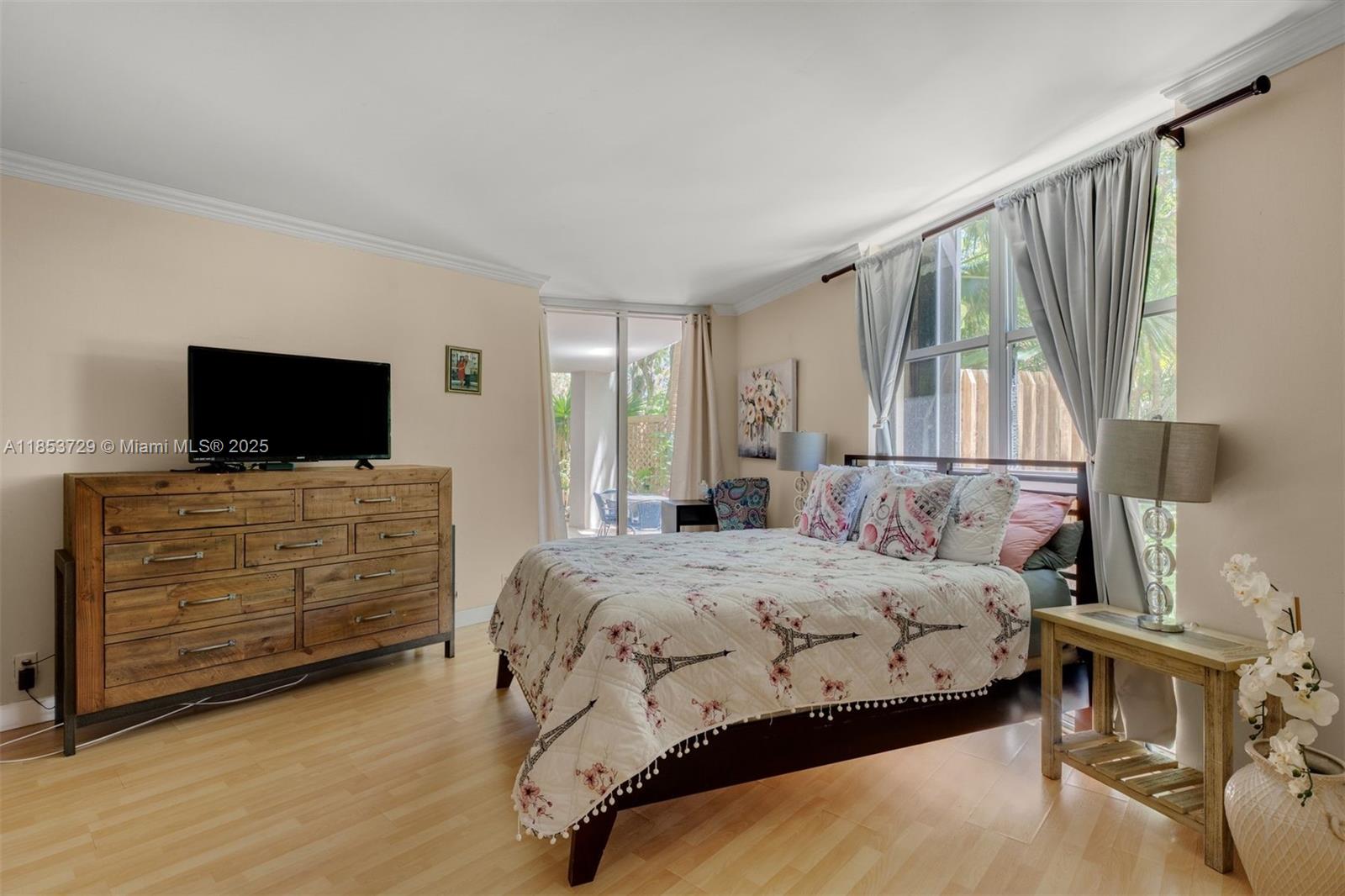 2000 Towerside Terrace, Unit 308 Miami, FL 33138 - Photo 14 of 16 a bedroom with a bed and flat screen tv