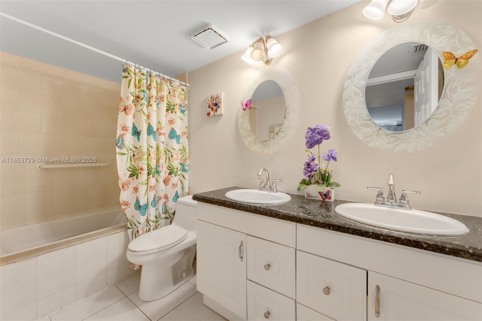 2000 Towerside Terrace, Unit 308 Miami, FL 33138 - Photo 15 of 16 a bathroom with a granite countertop sink a toilet and a mirror