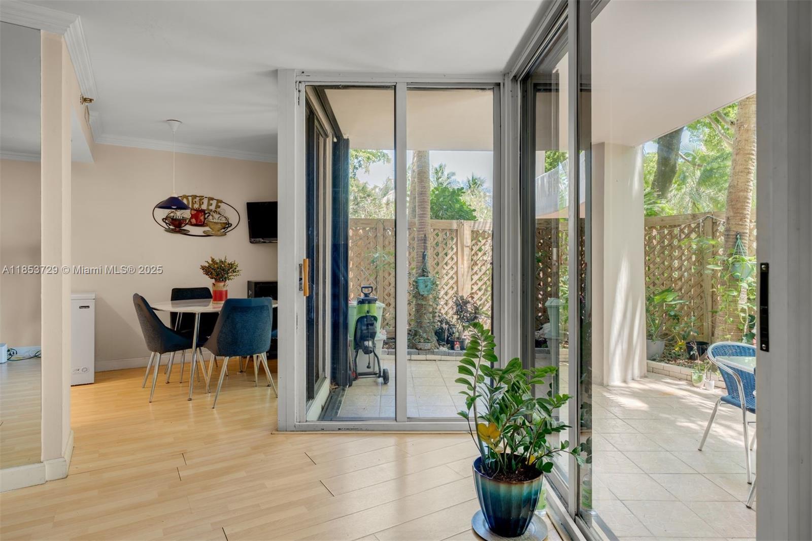 2000 Towerside Terrace, Unit 308 Miami, FL 33138 - Photo 4 of 16 a view of a dining room with furniture window and wooden floor