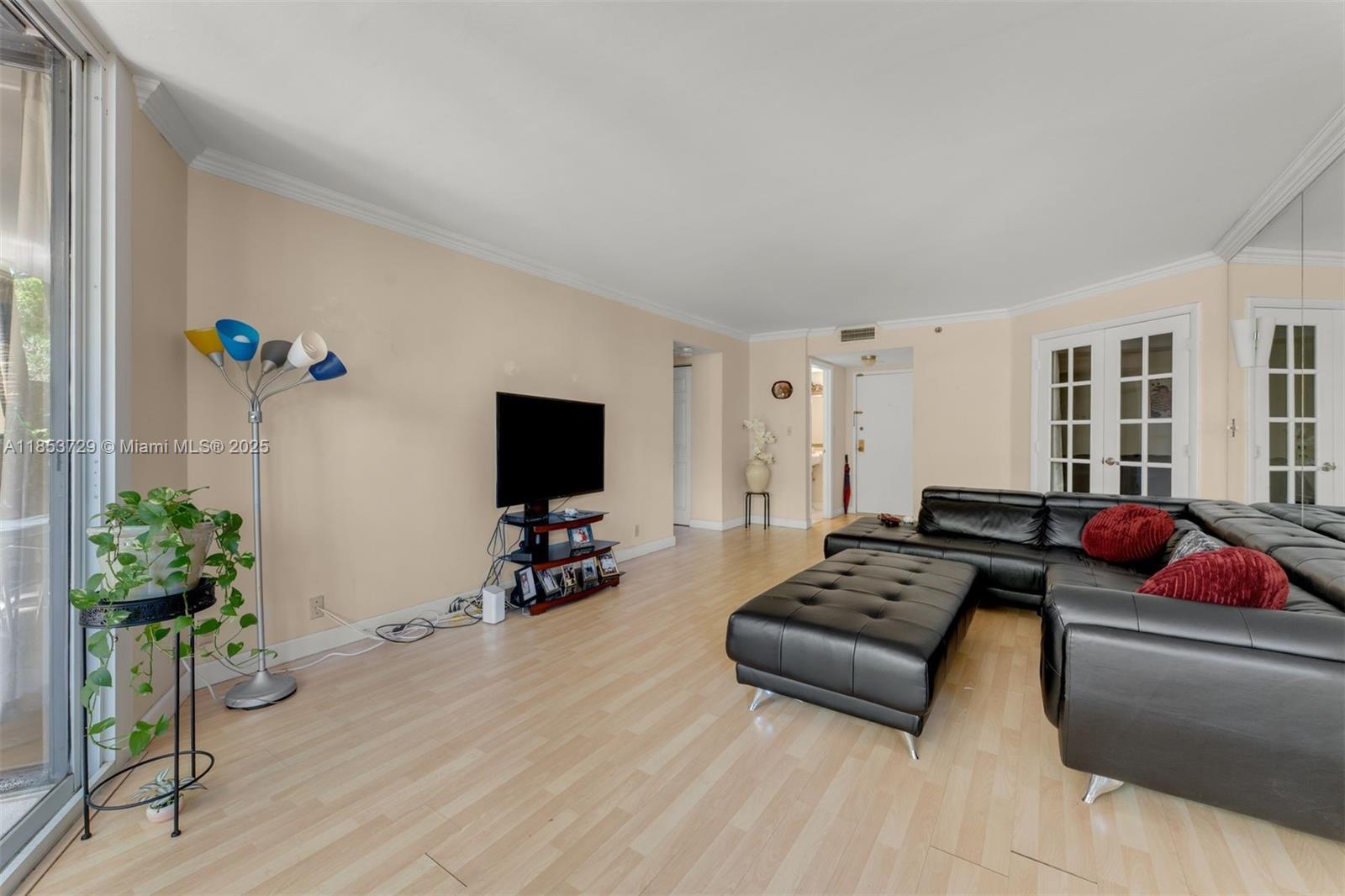 2000 Towerside Terrace, Unit 308 Miami, FL 33138 - Photo 6 of 16 a living room with furniture and a flat screen tv