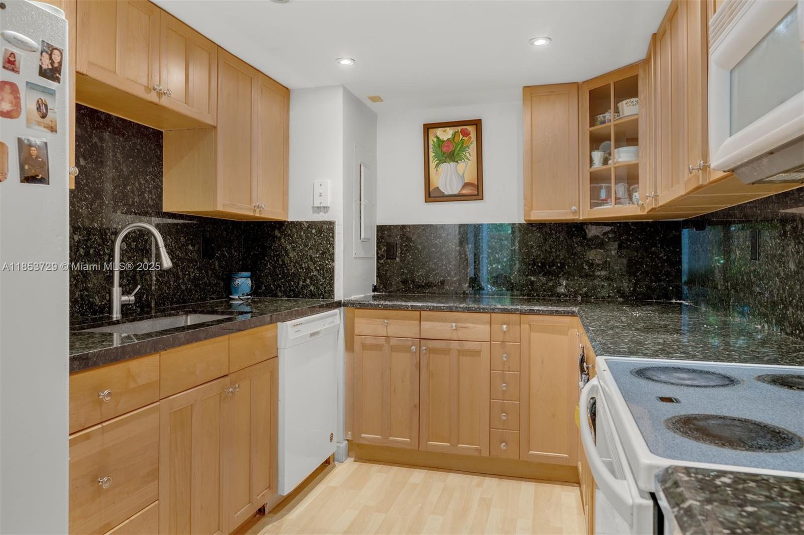 2000 Towerside Terrace, Unit 308 Miami, FL 33138 - Photo 8 of 16 a kitchen with stainless steel appliances granite countertop a sink and cabinets