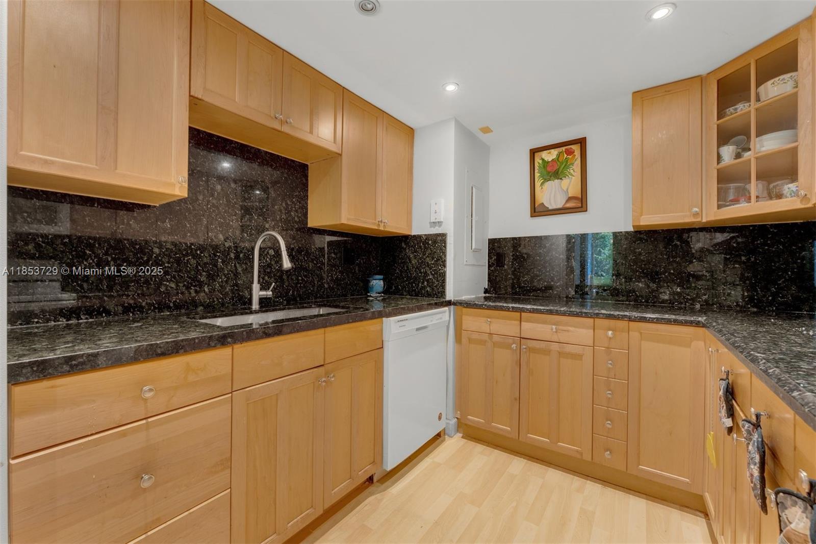 2000 Towerside Terrace, Unit 308 Miami, FL 33138 - Photo 10 of 16 a kitchen with stainless steel appliances granite countertop a sink and cabinets